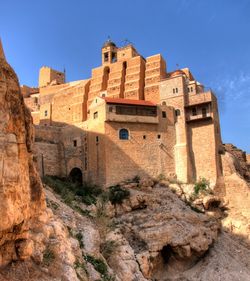 Low angle view of historic building against blue sky