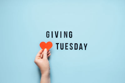 Giving tuesday, give, help, donation, support, volunteer concept with red heart in female hands and