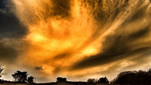 Low angle view of dramatic sky during sunset