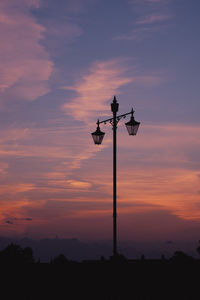 Low angle view of silhouette street light against sky during sunset