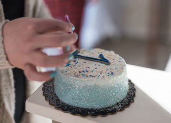 Close-up of hand holding cake