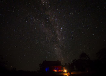 Low angle view of illuminated building against sky at night