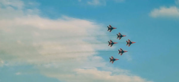 Low angle view of airshow against sky