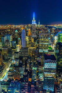 Aerial view of illuminated buildings in city at night