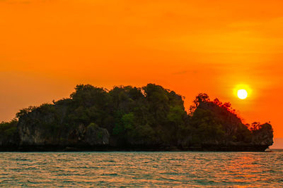 Scenic view of sea against orange sky