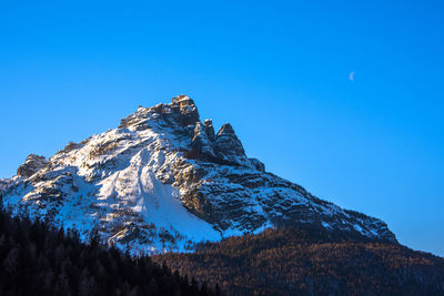 Scenic view of snowcapped mountains against clear blue sky