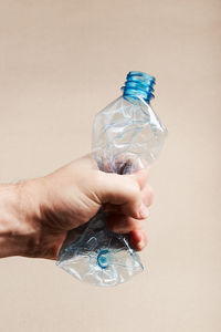 Close-up of hands holding plastic bottle