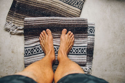 Low section of man wearing shoes