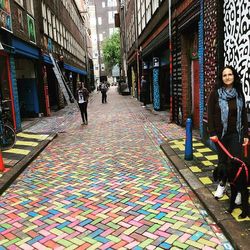 Woman walking on multi colored umbrellas