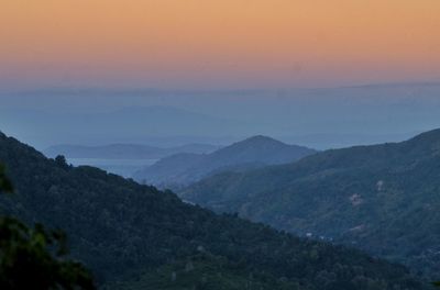 Scenic view of mountains against sky at sunset