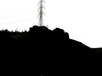 Low angle view of electricity pylon against sky