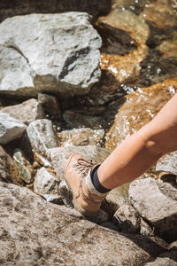 Low section of man walking on rock