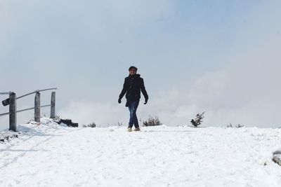 Full length of man standing on snow covered land