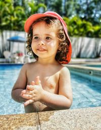 Brazilian baby girl playing at the swimming pool.