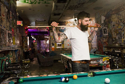 Young man at a pool hall