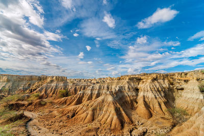 Scenic view of rock formations against cloudy sky at tatacoa desert