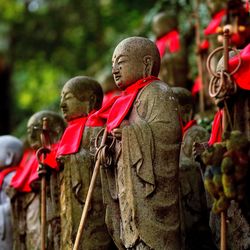 Sculptures of buddha in row outdoors