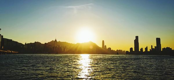 Scenic view of buildings against sky during sunset
