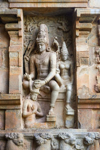 Statue against historic building