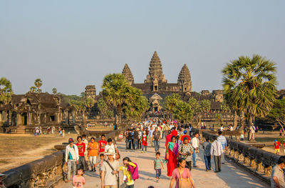 Group of people at temple against clear sky