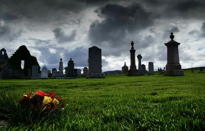 Bouquet and tombstones in cemetery