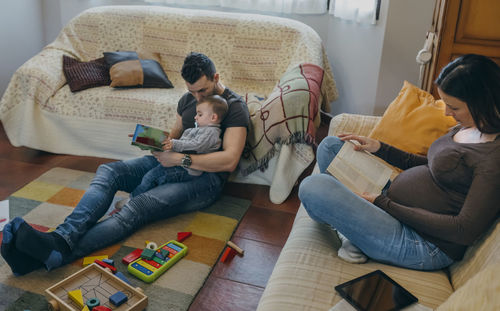 High angle view of woman sitting on sofa at home