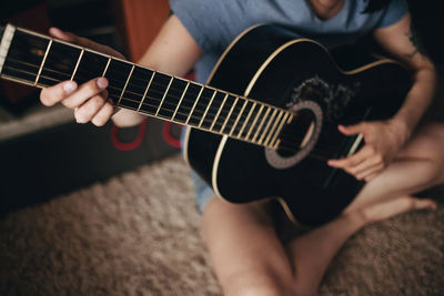 Close-up of hands playing guitar