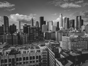 Aerial view of buildings in city against sky