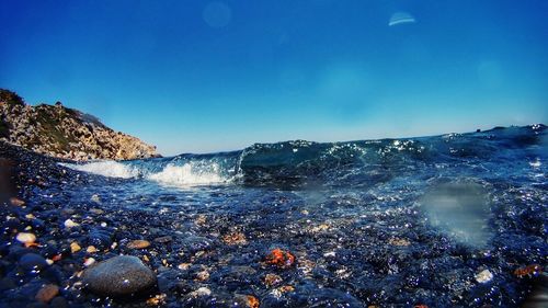 Scenic view of sea against clear blue sky