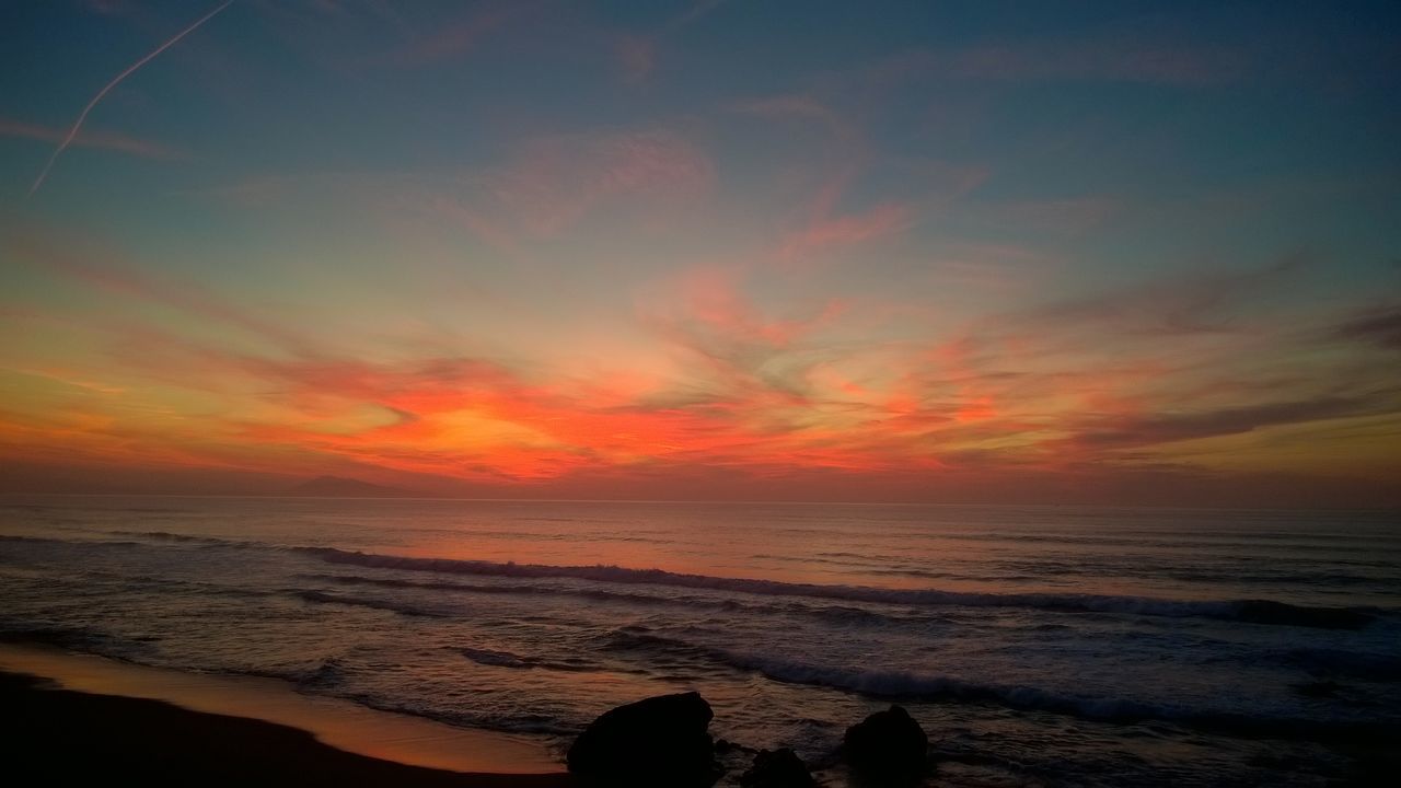 sunset, sea, beach, beauty in nature, sky, scenics, tranquil scene, nature, orange color, horizon over water, tranquility, cloud - sky, water, outdoors, silhouette, wave, vacations, no people, day