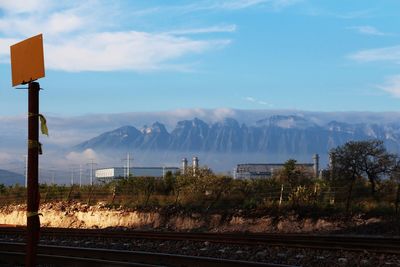 Railroad tracks, power plant and mountains