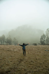 Rear view of man standing on field