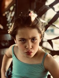 Girl making face while looking away at home