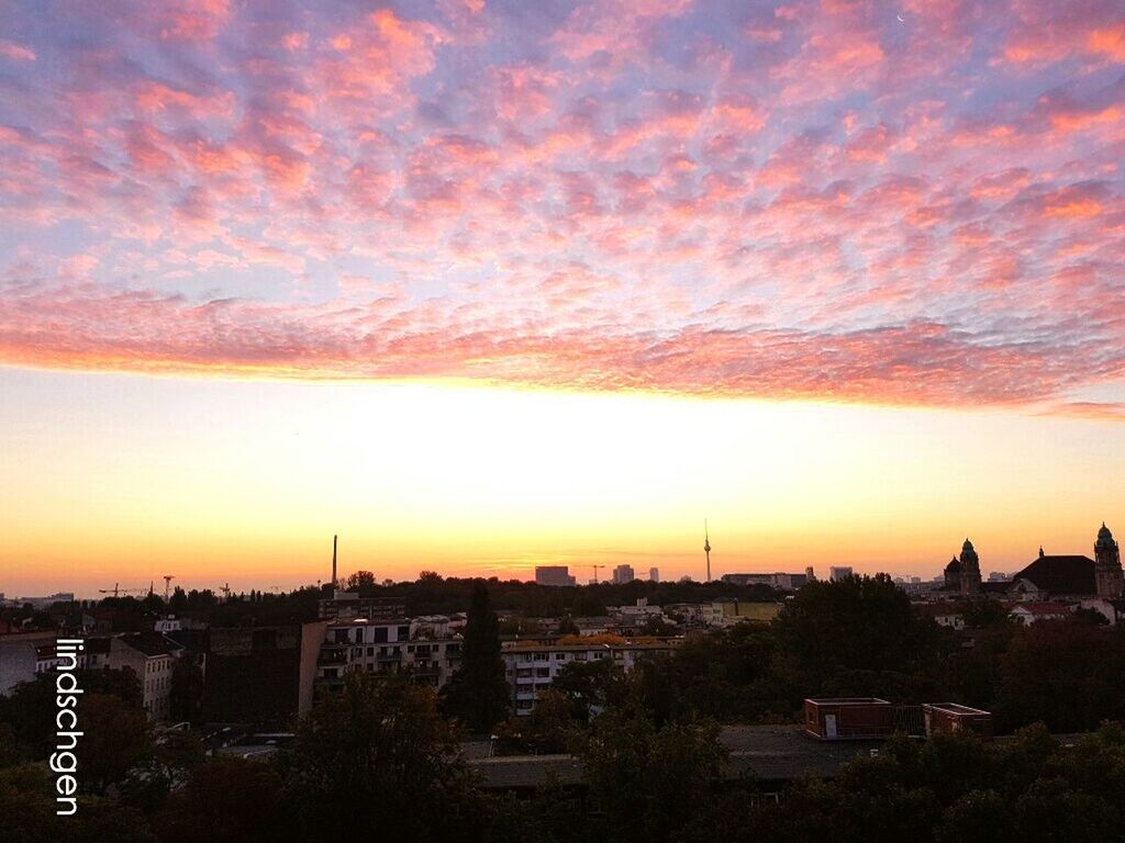sunset, architecture, built structure, building exterior, city, cityscape, orange color, crowded, high angle view, sky, romantic sky, cloud - sky, city life, scenics, outdoors, dramatic sky, beauty in nature, nature, no people, majestic, residential district, dawn, urban skyline, town, development, atmosphere, vibrant color