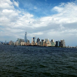 River in front of cityscape against clear sky