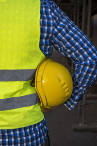 Midsection of man holding balloons