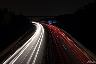 High angle view of light trails on road at night