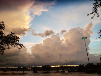 Low angle view of street lights against sky during sunset