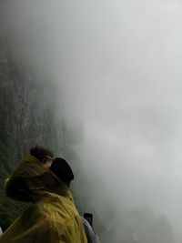 Man on mountain in foggy weather