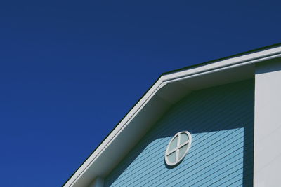 Low angle view of building against clear blue sky