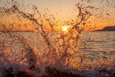 Close-up of sea against sky during sunset