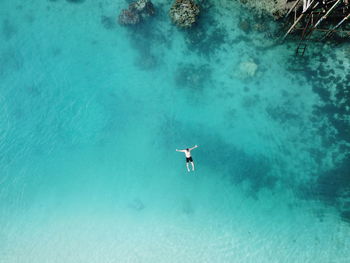 Aerial view of man swimming on sea