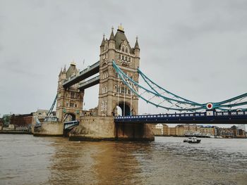 View of bridge over river against cloudy sky