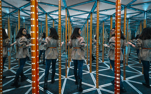 Young woman in mirror maze