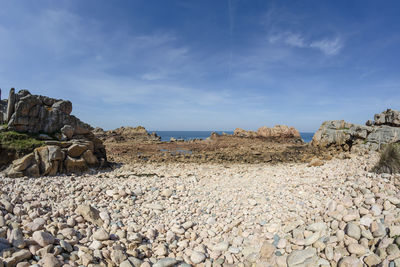 Rocks on beach against sky