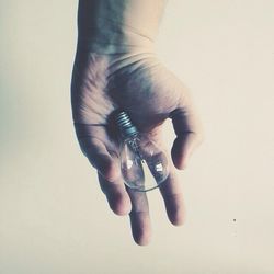 Close-up of hand over white background