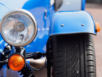 Close-up of vintage car on road