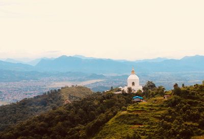 Stupa on mountain against sky