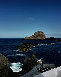 Scenic view of sea against clear blue sky