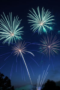 Low angle view of firework display at night